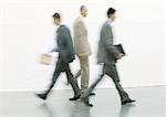 Businessmen walking, blurred motion