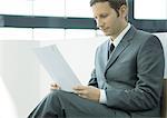 Businessman sitting and reading document