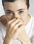 Woman covering mouth and nose with hands, portrait