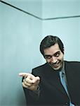 Businessman smiling and pointing