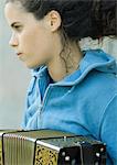 Young woman playing accordian