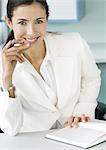 Businesswoman at desk, portrait