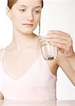 Woman looking at glass of water