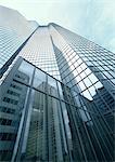 Skyscraper, building reflected in window panes, low angle view