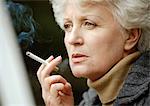 Woman smoking cigarette, close up