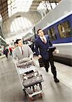 Businessmen running on train platform, blurred.