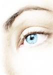 Woman's blue eye, extreme close-up, blurred.