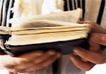 Jewish man's hands holding Torah, close-up