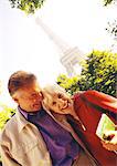 France, Paris, mature woman and man smiling, Eiffel Tower in background, portrait