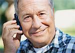 Mature man with a cell phone, close-up, portrait