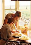 Man and child making apple pie