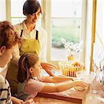 Woman and children cooking