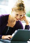 Woman with laptop computer, smiling