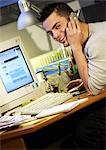 Man sitting at desk with cell phone