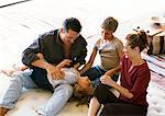 Parents and children playing on mattress