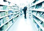 Person standing in aisle in supermarket, blurred