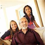 Senior man and girls smiling