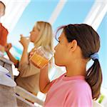 Girl having breakfast with family, side view