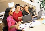 People working with laptops in office, close-up