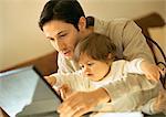 Father and baby using laptop