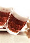 Two mugs of beer, close-up