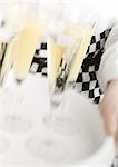 Waiter carrying tray of champagne, blurred motion, close-up