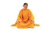 Buddhist monk meditating in lotus position