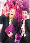 Young business couple using cell phones, digital composite.