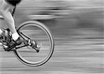 Man cycling, side view, low section, b&w.