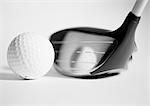 Golf club and ball, close-up, b&w.