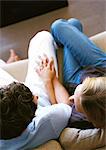 Couple sitting on sofa together, elevated view