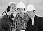 Two men and woman wearing hard hats, b&w