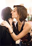 Women kissing cheeks, close-up