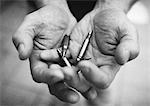 Hands holding bullets, close-up, b&w