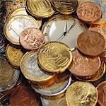 Assorted euro coins and pocket watch