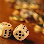 Dice in front of blurred pile of coins