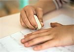 Hands holding eraser on notebook