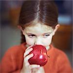 Girl smelling apple, portrait