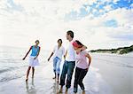 Two couples walking on beach