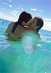 Couple kissing in sea