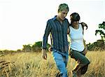 Couple walking in field