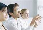 Business people in meeting, man with glasses gesturing