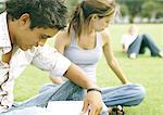 Students sitting on grass, studying