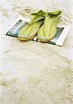 Espadrilles on newspaper on beach