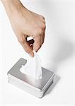 Hand taking tissue from dispenser