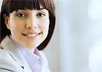 Woman in suit smiling, portrait