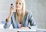 Businesswoman looking at cell phone