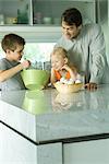 Father cooking with son and daughter