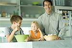 Father cooking with son and daughter