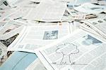 Drawing of tree on pile of newspaper